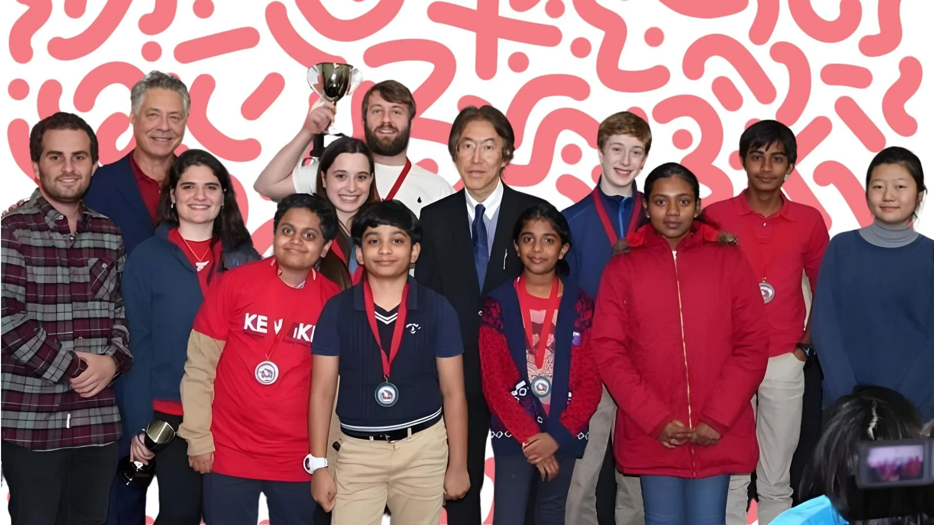 KenKen champions, with their medals and trophies, beside the organizers at an international championship
