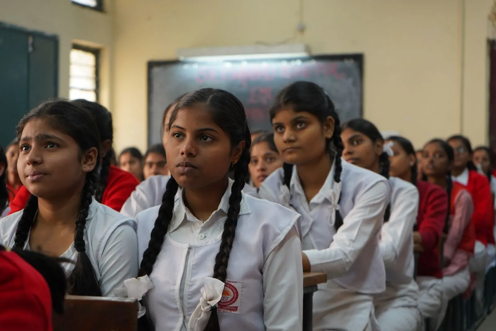 Students in uniform listening in an Indian classroom